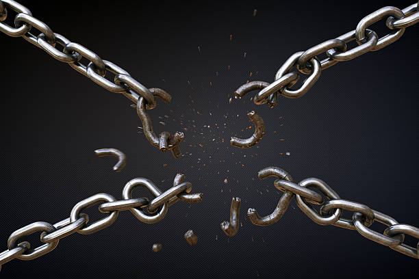 Broken Chain A04 This scene shows four chains positioned in the shape of the letter X, falling apart. The chains central links are breaking apart under strain of force and iron fragments are blowing out. The chains look rugged, rusty and dirty. The scene is isolated on a dark blue patterned background. broken chain stock pictures, royalty-free photos & images
