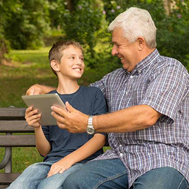 istock Grandfather and grandson in the park 478735763