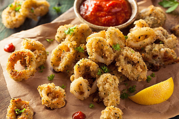 Homemade Breaded Fried Calamari Homemade Breaded Fried Calamari with Marinara Sauce calamari photos stock pictures, royalty-free photos & images
