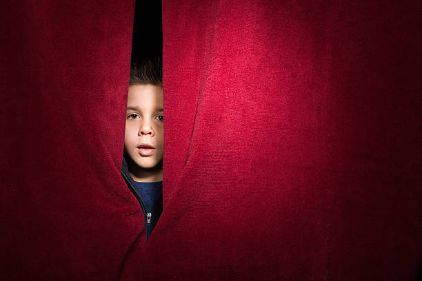 istock Child appearing beneath the curtain 478736783