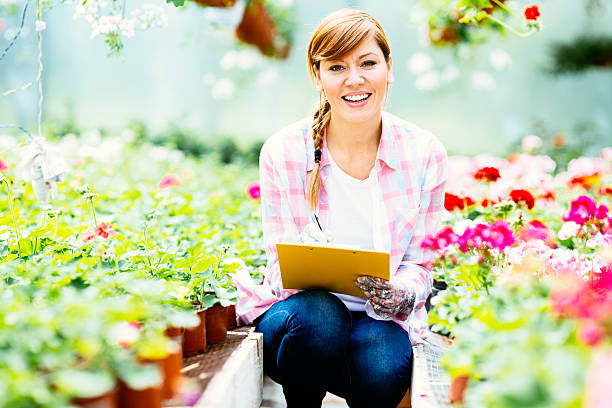 istock Female florist working at Greenhouse. 478740078
