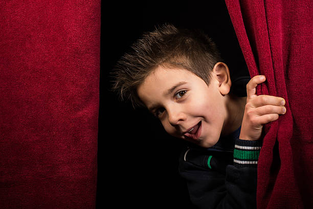 A young business group of children stand on a stage looking through binoculars ready to search for new solutions and strategy for your business. 