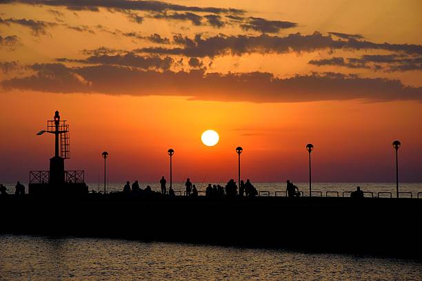 istock Sunset, lighthouse and fishermen 478743700