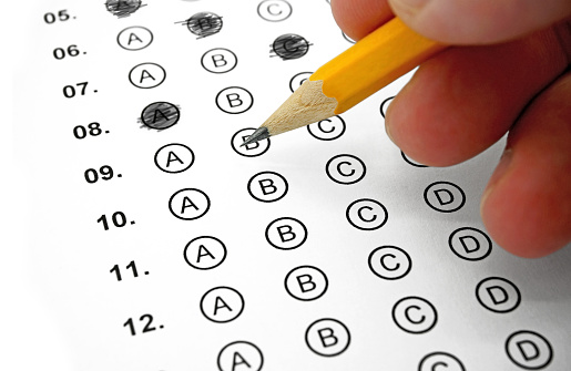 Filling out Answers on a Multiple Choice Test with a Yellow Pencil - Close Up View