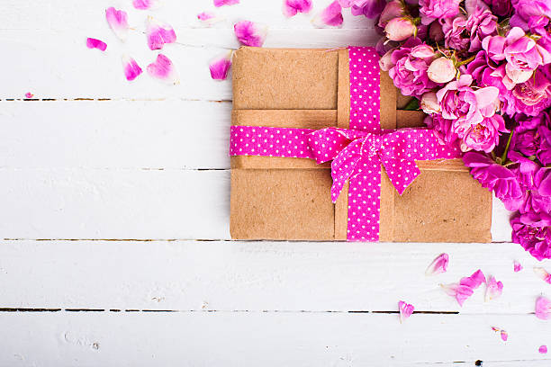 istock Vintage background with a gift and flowers on a wooden surface 478748896