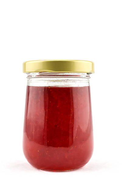 istock Strawberry marmalade jam in glass jar isolated on white 478751654