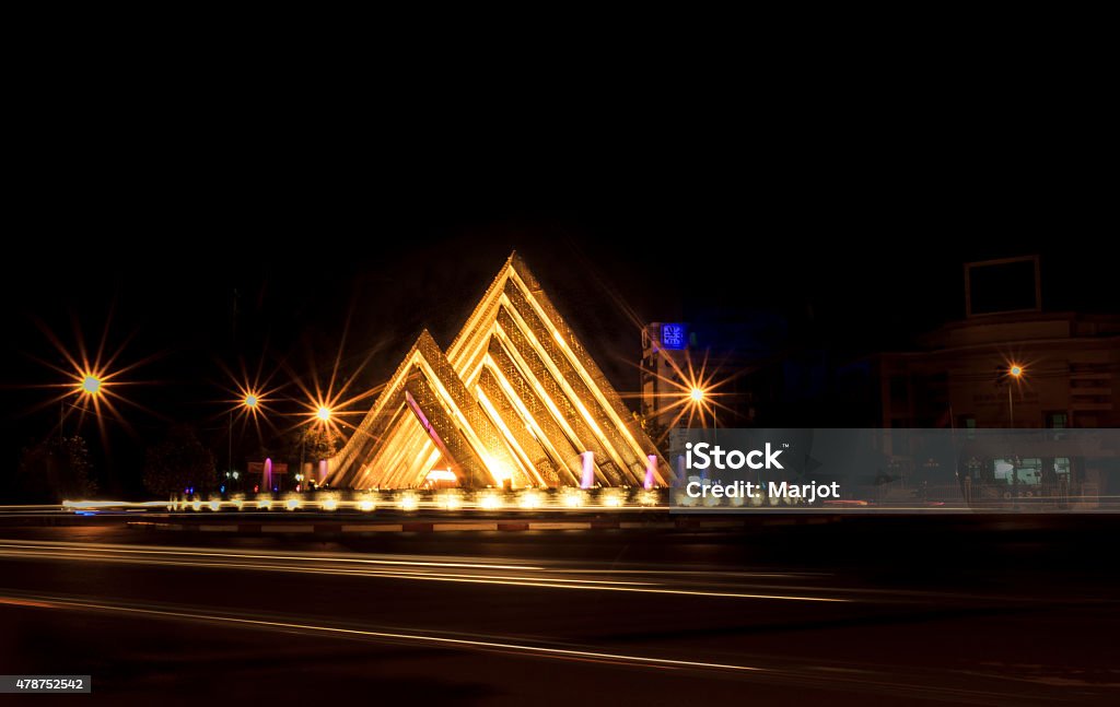 Pyramids Traffic-circle New icon at Tayninh city, Vietnam, 05-2015. Works of JSC Investment advisory and Binh Chanh District (HCMC). Buildings symbols of Tay Ninh province has two large and small blocks in the shape of several lopsided Ba Den Mountain stylized, reflecting on Dau Tieng Lake. 14m-high main building blocks, designed to balance and harmony of architecture and matching landscape. This work has been put at the roundabout intersections between downtown. Works were completed on 27.04.2015. 2015 Stock Photo