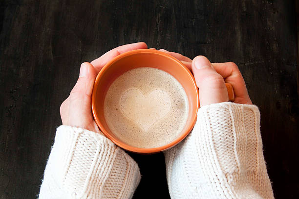 istock Hands Holding Cup of Coffee with Heart Shape 478756139