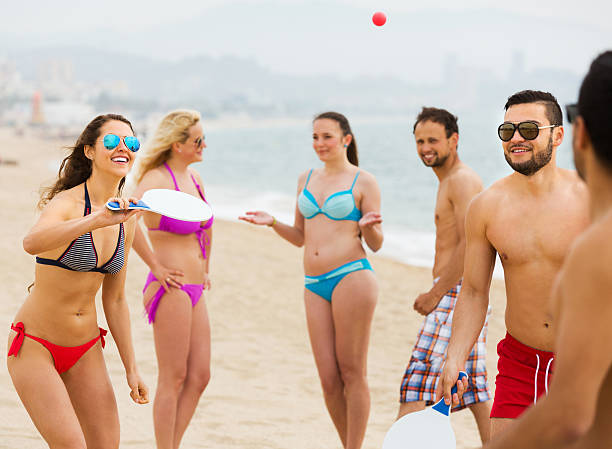 istock Friends playing with rackets at beach 478758258