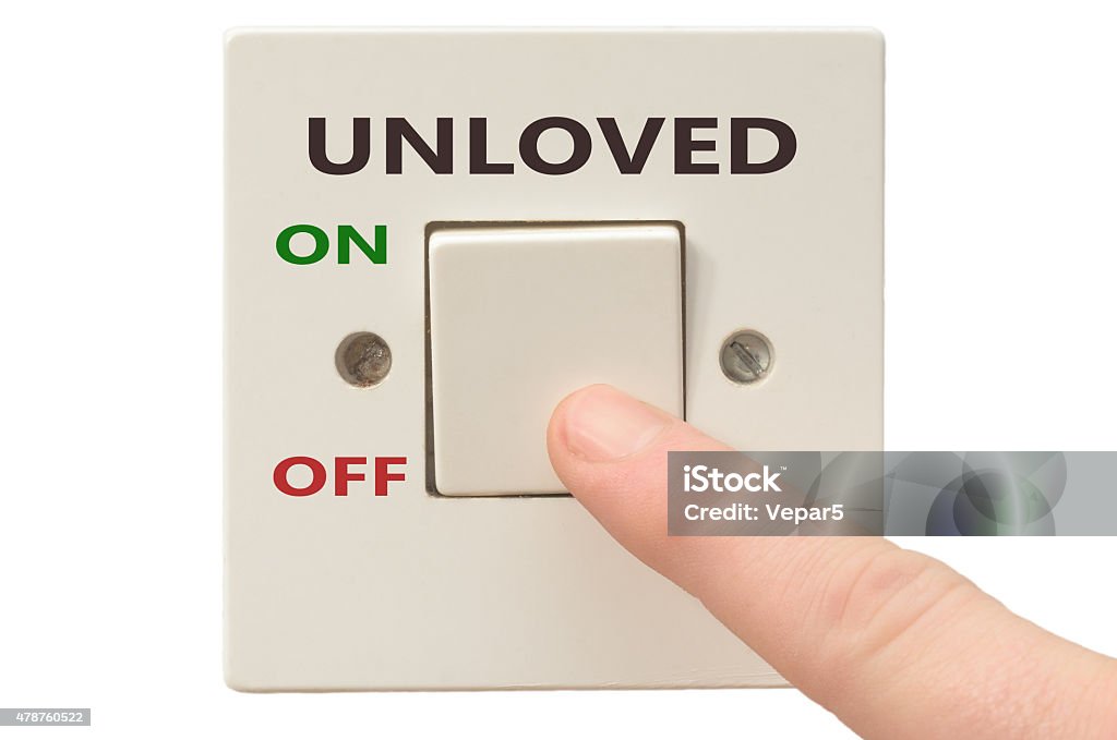 Dealing with Unloved, turn it off Turning off Unloved with finger on electrical switch 2015 Stock Photo