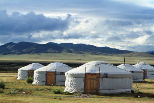 Gers used by nomadic families in Ovorkhangai\nProvince, Mongolia at sunrise.