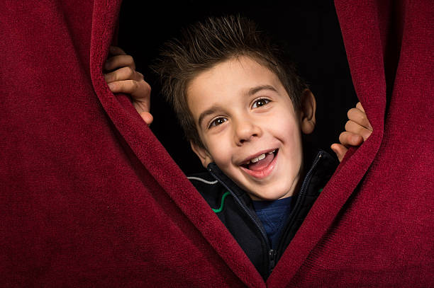 istock Child appearing beneath the curtain 478764919