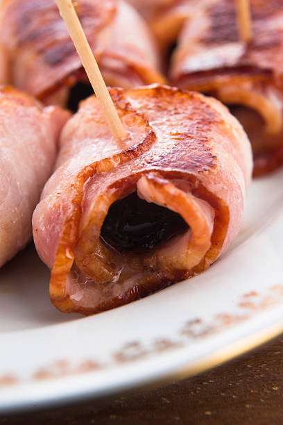 istock Baked prunes in bacon on a plate 478765127
