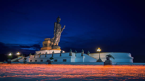istock Candle lit from buddhists are moving around Buddha statue 478765244