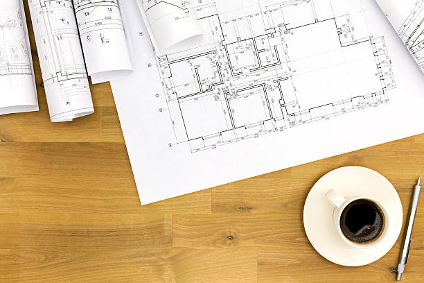istock coffee cup with blueprints on wooden table 478768842
