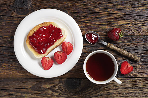 istock Tea cup and toast with strawberry jam 478769442