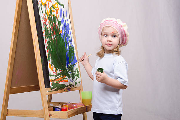 istock Girl artist paints on canvas 478769703