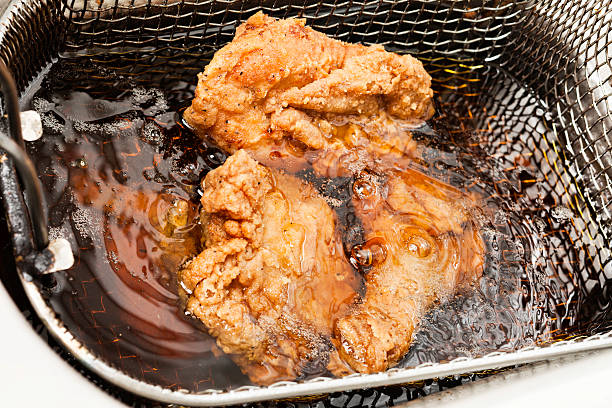 Deep frying chicken stock photo