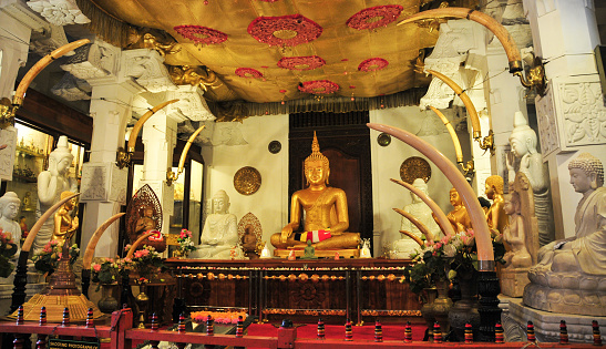 KANDY, SRI LANKA - FEBRUARY 26, 2014. Buddha statues inside the Temple of the Tooth. The Sacred Tooth Relic of the Buddha attracts thousands of pilgrims and tourists to the sacred city of Kandy.
