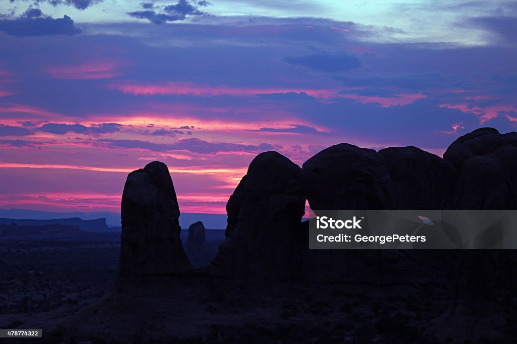 Arches National Park At Sunset Arches national park at sunset, a rocky silhouette against a colorful sunset. Very close to the Windows Arches location. American Southwest sunset. 2015 Stock Photo