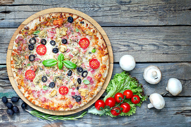 istock Pizza on old vintage retro wooden boards 478774600