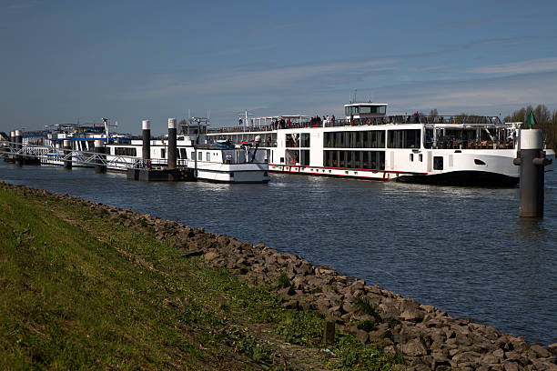 Cruise ships in Dutch river Lek Kinderdijk, Netherlands - April 16, 2015: Passengers visiting Unesco World Heritage Site Kinderdijk lek river in the netherlands stock pictures, royalty-free photos & images