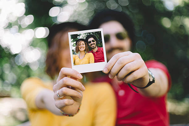 istock Eccentric couple holding instant photo 478775128