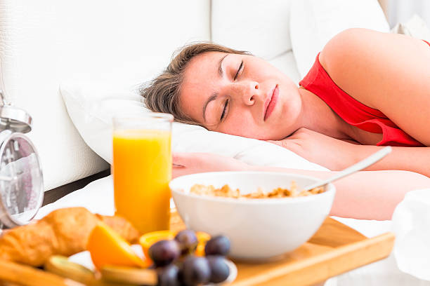 istock breakfast on a tray beside the bed sleeping girl 478775482