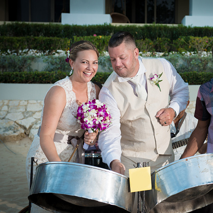 Bride and Groom playing steel drums at a Jamaican destination wedding