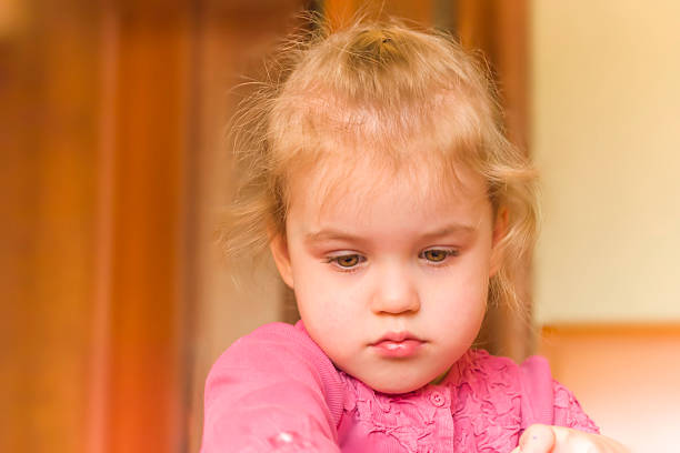 istock Little girl busy playing against interior background 478778349