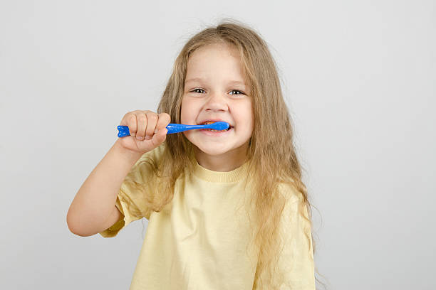 istock Four-year girl brushing her teeth 478780534