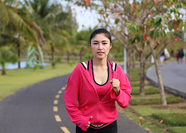 istock young healthy asian woman running 478782346