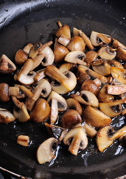 istock Fried sliced mushrooms in butter in a frying pan 478782806