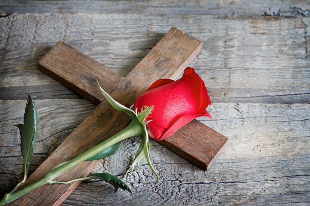 Cross and red rose sign symbol religion concept Cross and red rose sign symbol religion concept on wooden board self sacrifice stock pictures, royalty-free photos & images