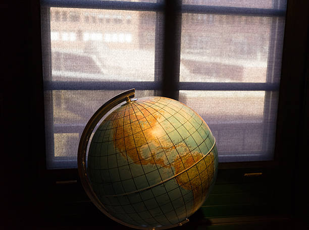 istock Geographic Globe in the dark room against a window 478788178
