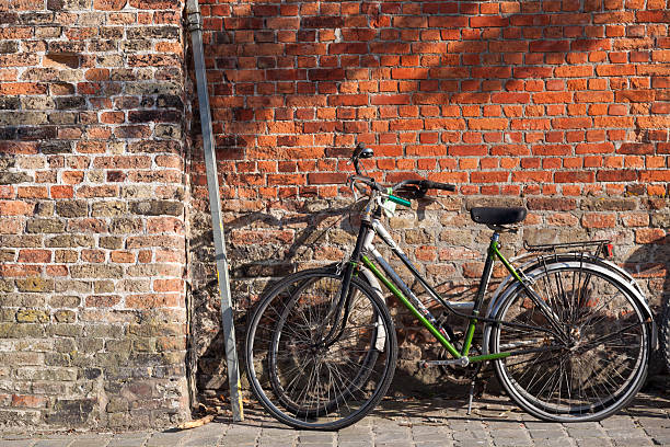istock Bicycles on the pavement near brick wall 478790690