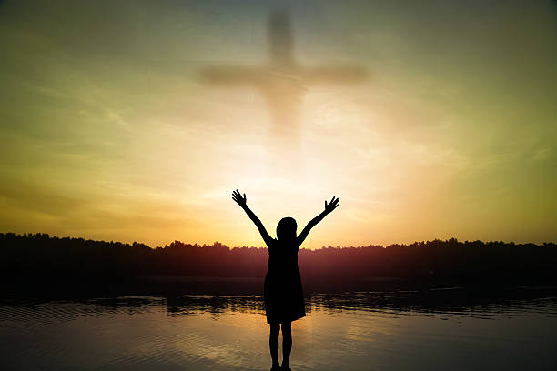 istock girl standing arms out stretched at sunset 478791158