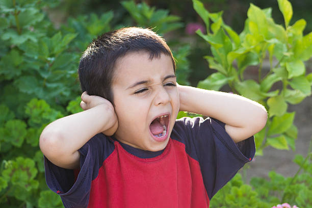 mały chłopiec krzyczy i obejmujące uszy - emotional stress irritation hands covering ears displeased zdjęcia i obrazy z banku zdjęć