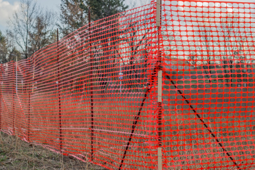 Orange plastic Construction Mesh Safety Fence at the building site