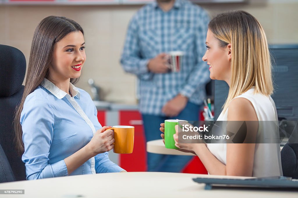 Coffee Break Coffee break in an office for two young businesswomen 2015 Stock Photo