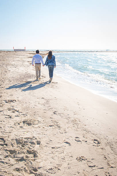 istock Couple on the beach walking away 478796855