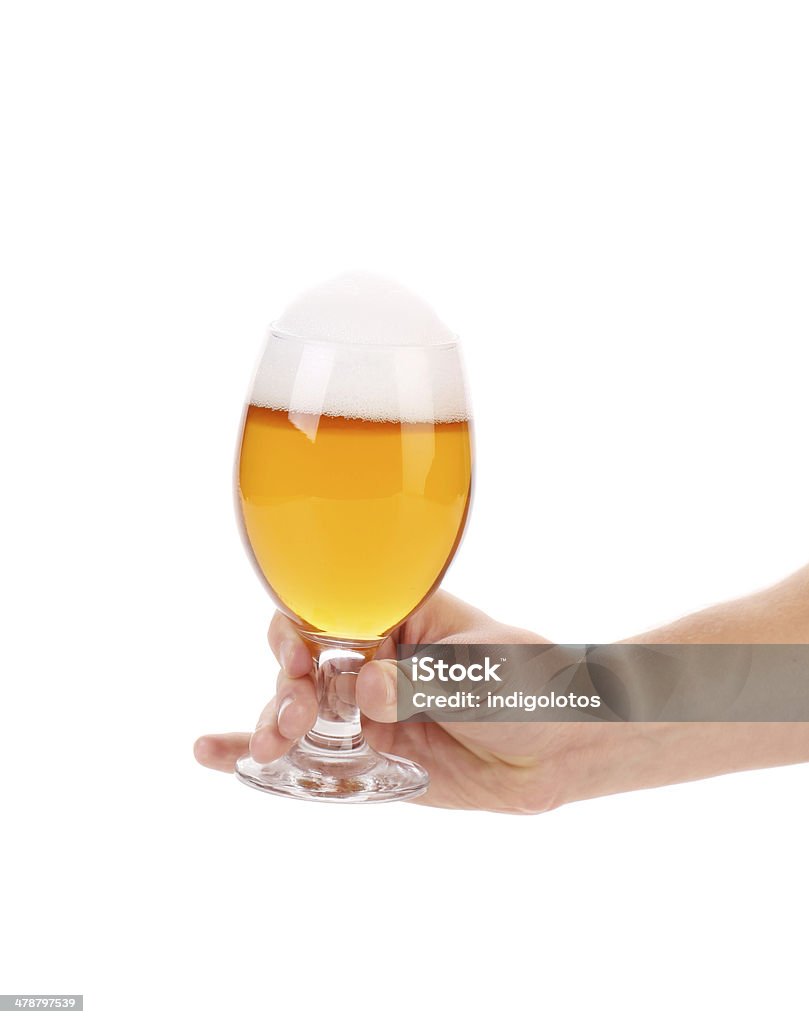 Glass of light beer in hand. Glass of light beer in hand. Isolated on a white background. Alcohol - Drink Stock Photo