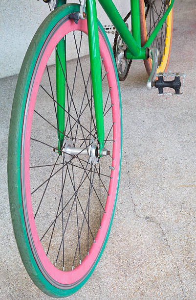 istock wheel of green fixed gear bicycle at building 478798030