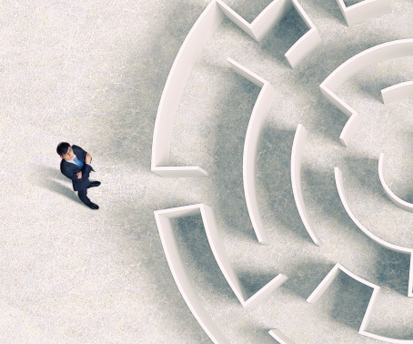 Top view of successful businessman standing near the entrance labyrinth