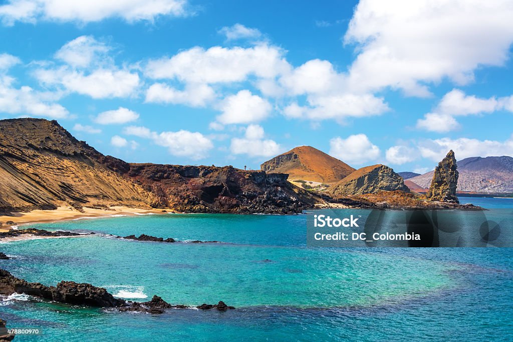 Underwater Crater and Pinnacle Rock View of an underwater crater in the foreground with Pinnacle Rock in the background on Bartolome Island in the Galapagos Islands Galapagos Islands Stock Photo