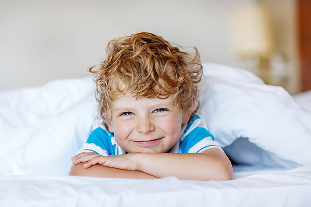 istock Little blond child sleeping in his bed with toy. 478801280