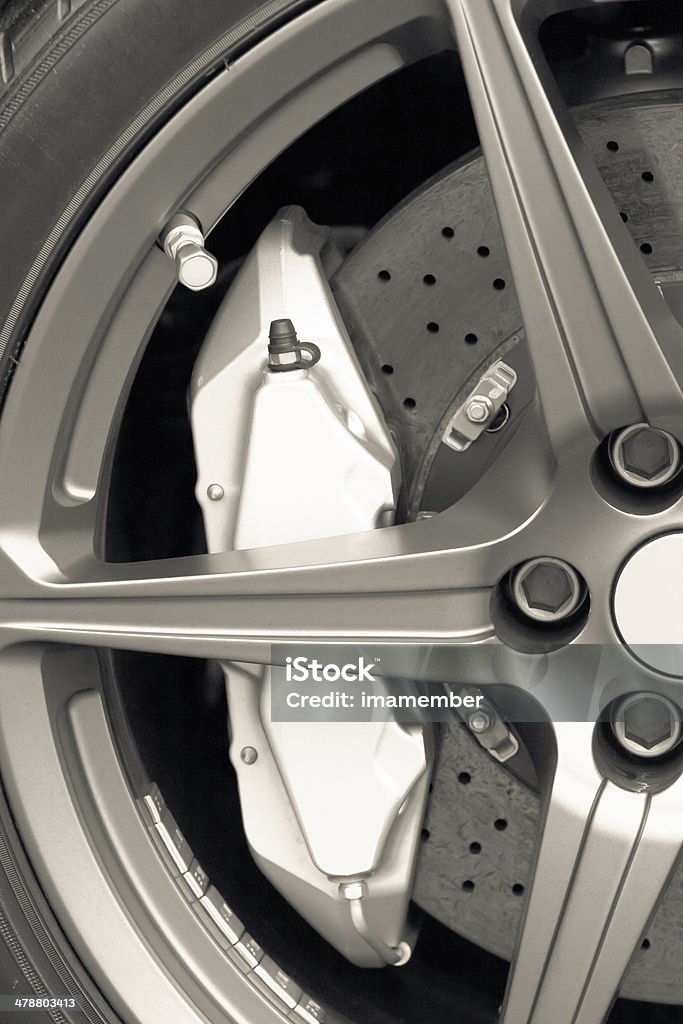 Alloy wheel with a carbon ceramic barke on sports car Closeup sports car alloy wheel with carbon ceramic brake, full frame vertical composition Alloy Wheel Stock Photo