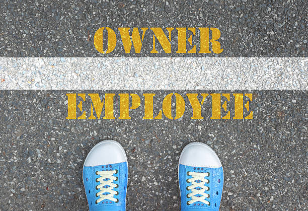 istock Shoes standing at the line between employee and owner 478803418