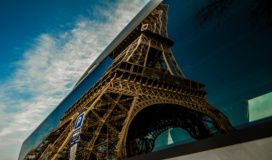 The Eiffel Tower Reflected off the side of a tour bus