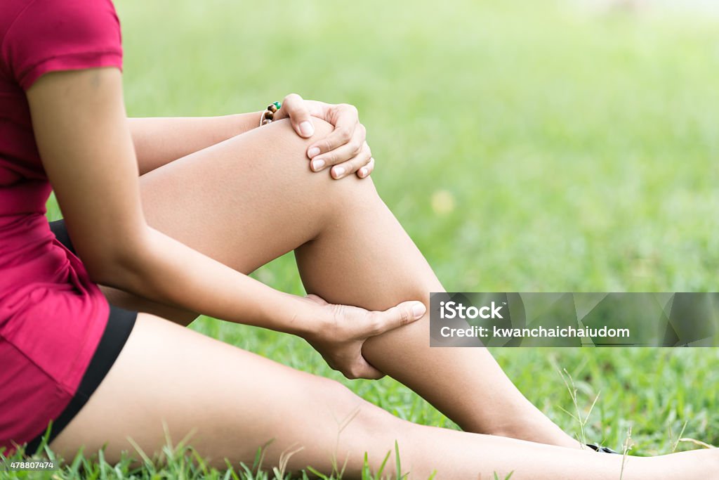 Leg Pain In A Woman Leg Pain In A Woman on green background Calf - Human Leg Stock Photo